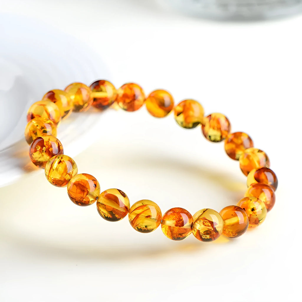 Natural yellow piebald amber bracelet with geometry beads on wrist