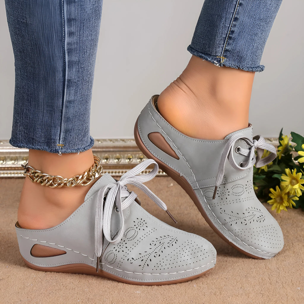 Women's suede lace-up wedge slippers in light grey, showing hollow-out design and rubber sole.