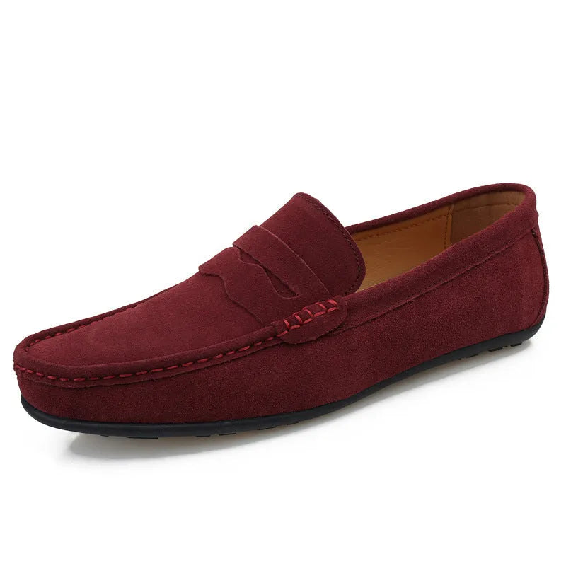 Men's solid colour suede leather slip-on loafers with round toe and flat rubber sole.
