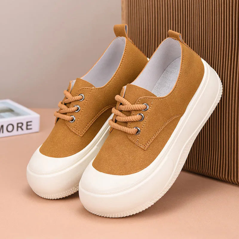 Women's beige suede platform loafers with round toe and lace-up front on a flat rubber sole.