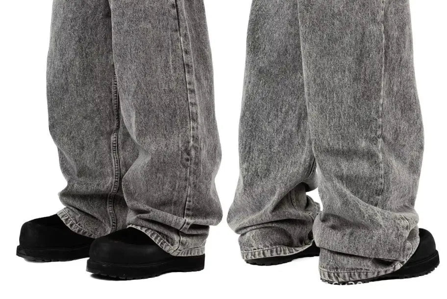 Grey loose straight-leg cotton denim trousers for men and women on a hanger
