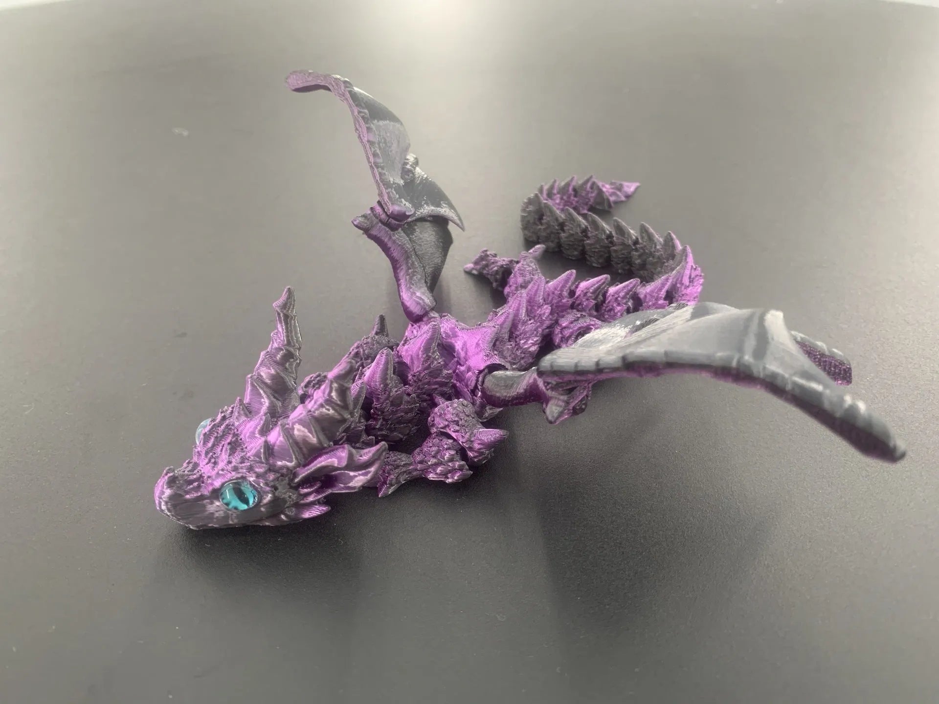 Red and gold printed dragon wings decorative toy made of PLA plastic.