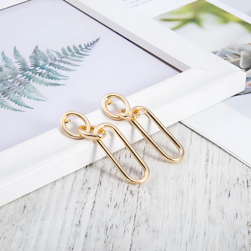Geometric sterling silver coloured alloy hoop earrings for women with a ring and line design.