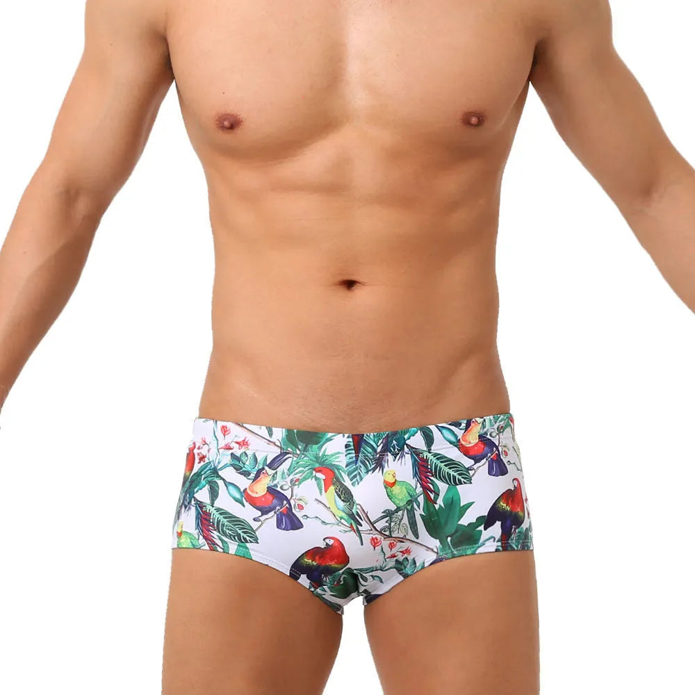 Men's navy swim trunks with colourful flower and bird print pattern, boxer style