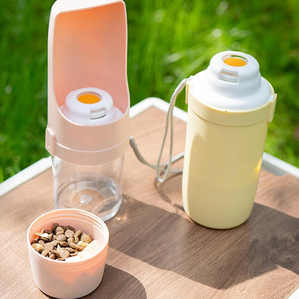 Grey portable 2-in-1 dog travel water bottle and feeder with detachable lanyard.