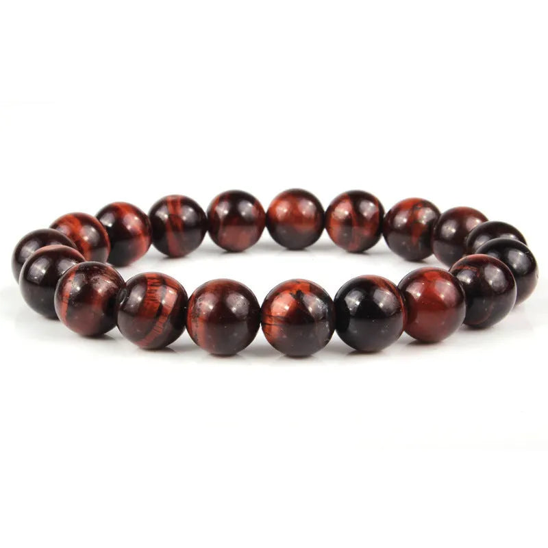 Natural tigereye crystal beaded bracelet with round beads, shown in a selection of colours and sizes on a wrist.