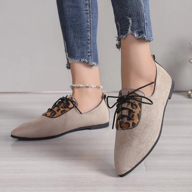 Beige leopard print women's pointed toe pumps with a faux PU upper and rubber sole.