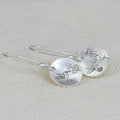 Silver circular earrings with bird and flower motifs in retro design