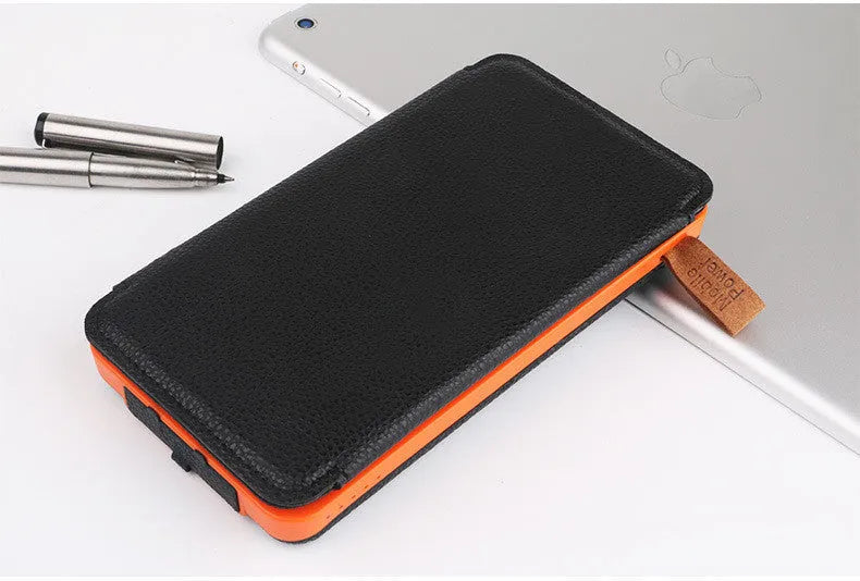 Outdoor solar power bank in black with solar panel, LED light, and soft leather exterior.
