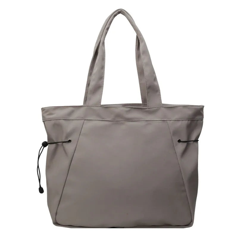 Soft Oxford cloth folding commuter shoulder tote bag shown in light grey colour.