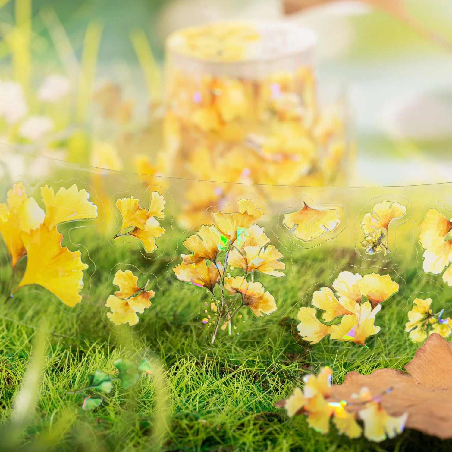 Roll of clear PET decorative stickers with repeating leaf patterns including ginkgo and maple designs.