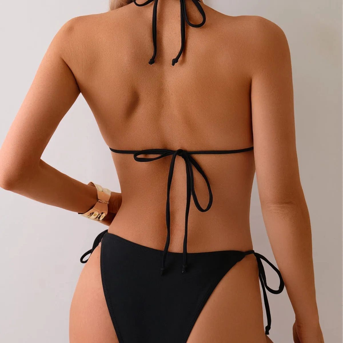 Black women's bikini swimsuit with metal bead split design on polyester fabric