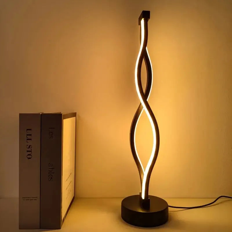 Black aluminum desk lamp with a touch dimming base on a wooden desktop.