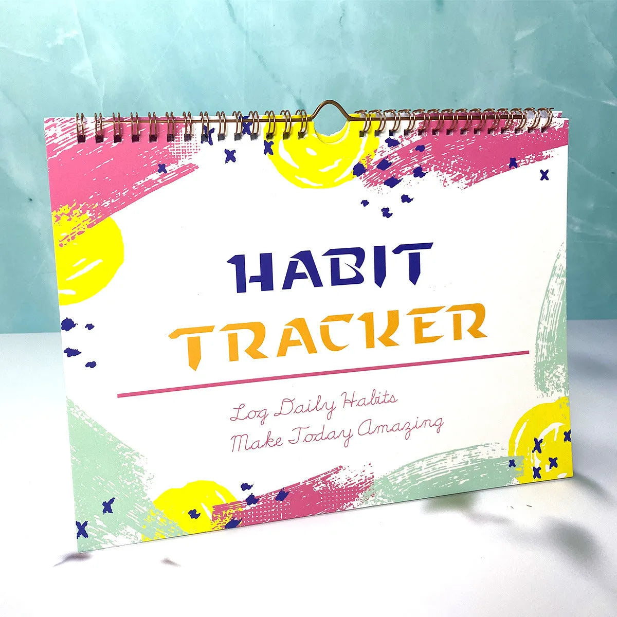 English habit tracking notebook with 12 pages in 21x28cm format showing four colour options