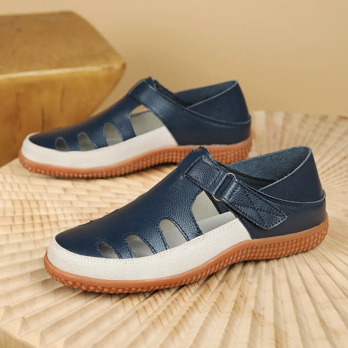 Plus size women's flat sandals in blue with a hollow toe cap and thick rubber sole.
