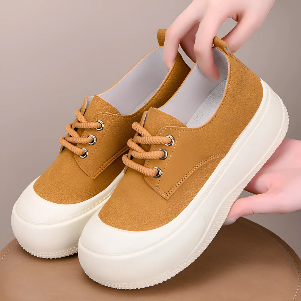 Women's beige suede platform loafers with round toe and lace-up front on a flat rubber sole.
