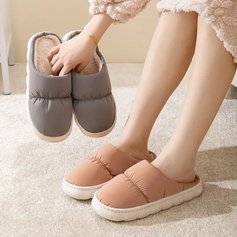 A pair of thick-soled plush slippers with artificial leather uppers and non-slip rubber soles in a choice of five colours.