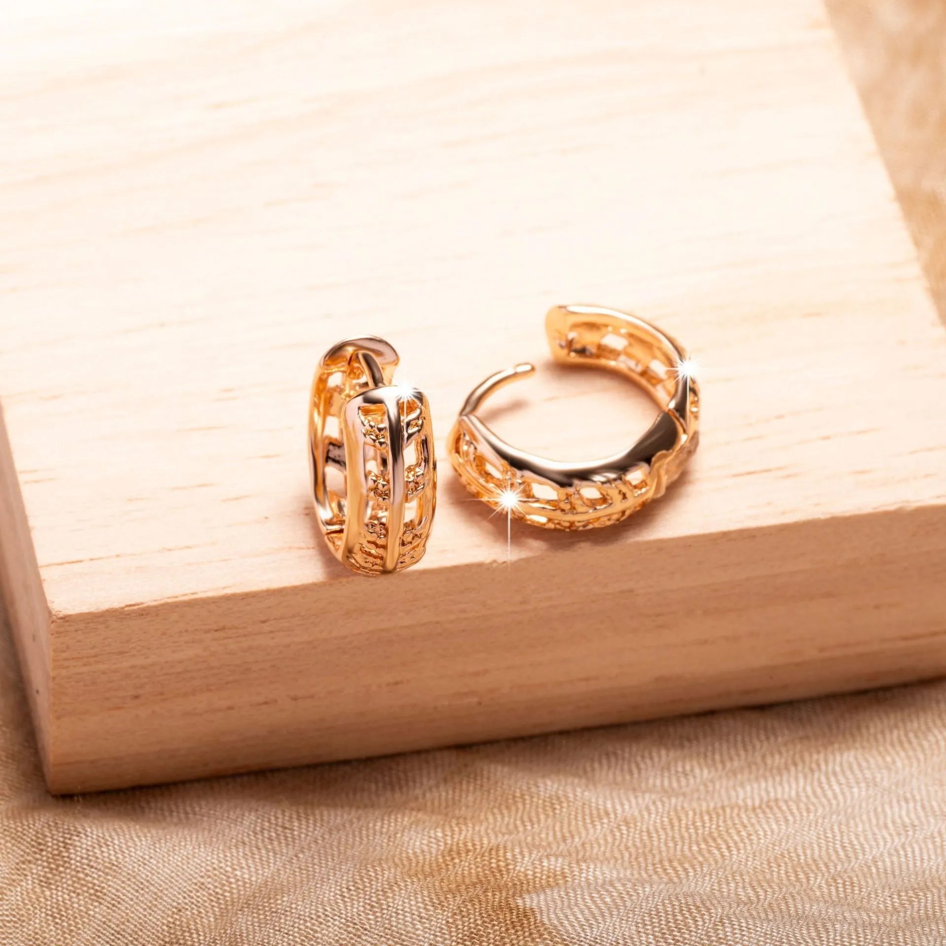 Rose gold copper earrings with hollowed-out heart and leaf designs on white background