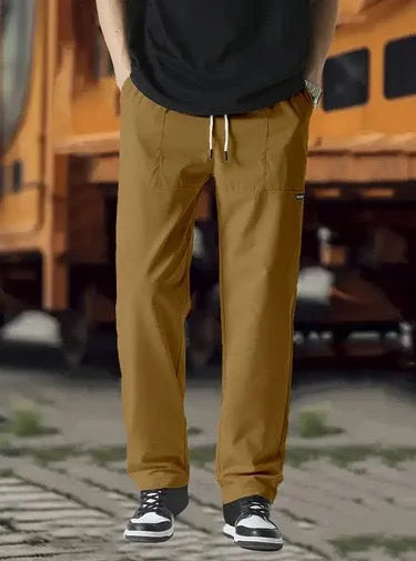Men's polyester trousers in light grey, shown flat, with a size label indicating S-XXXL range.