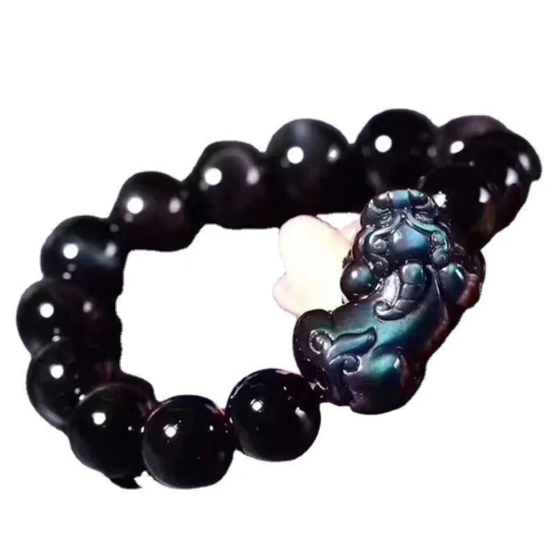Natural ice colour obsidian crystal bracelet with spherical beads on a neutral background.
