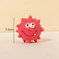 Set of four colourful natural latex squeaky dog balls with cute faces, shown with a dog.