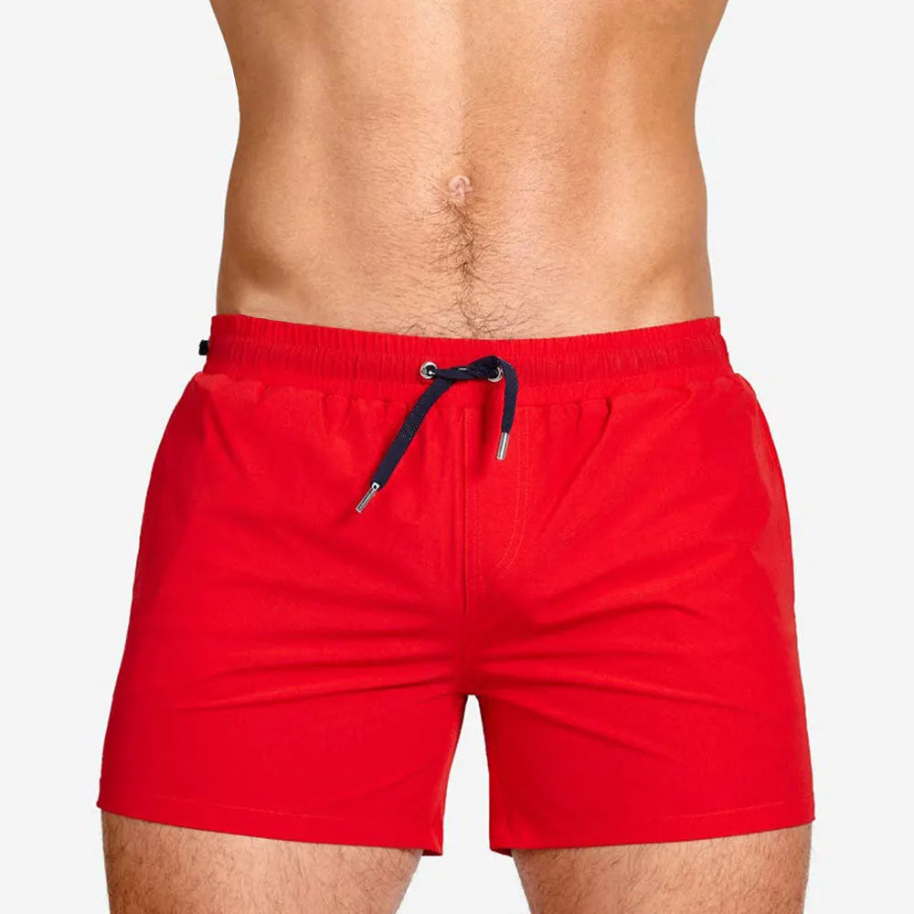 Solid colour swimming shorts with mesh lining for sports and fitness activities