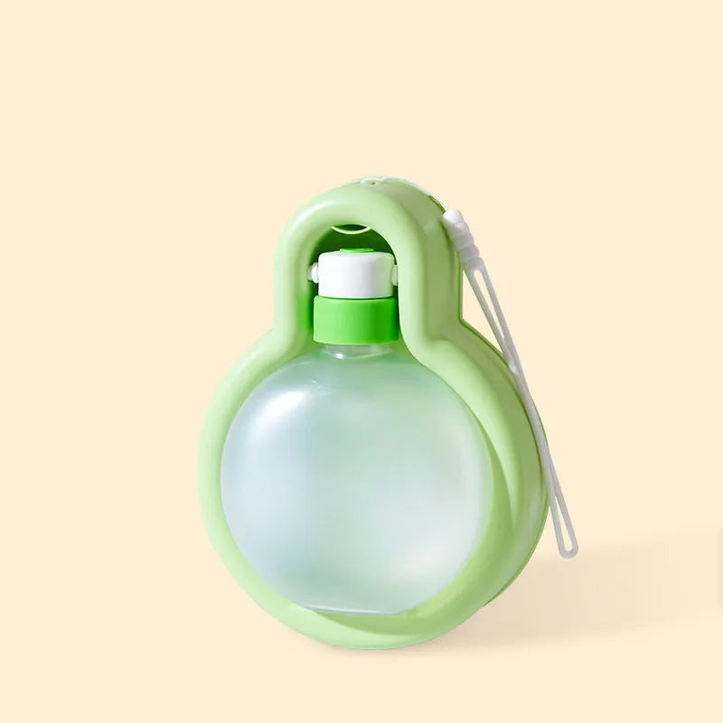 Green portable dog water bottle with retractable drinking bowl for travel and outdoor use.