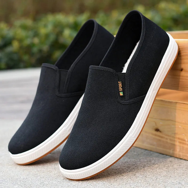 Men's black low-top canvas slip-on shoes with round toe and composite sole
