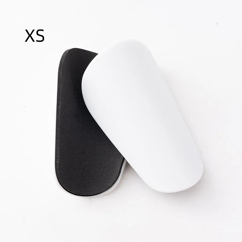 PU mini shin guards in various colours on a leg, showing S and XS sizing for sports protection.