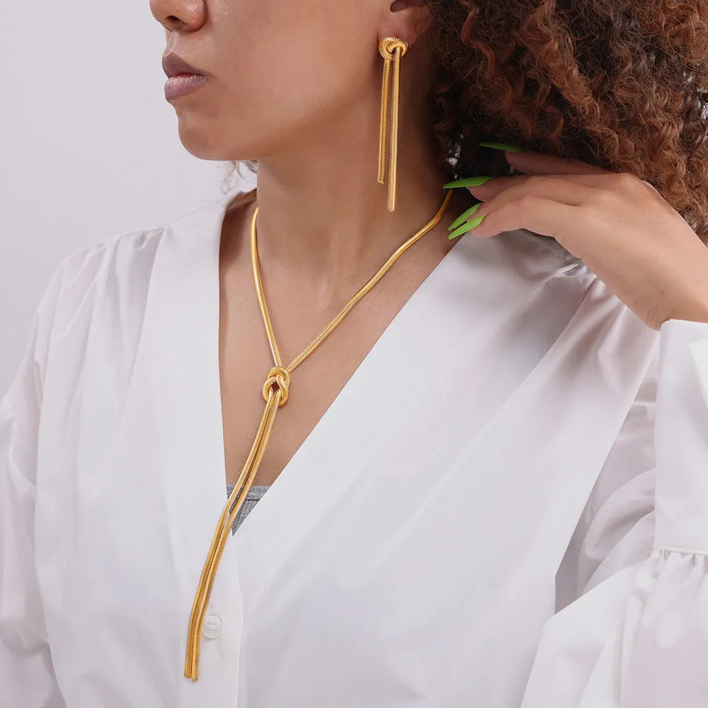 Gold electroplated titanium steel necklace with knotted tassel pendant and matching earrings