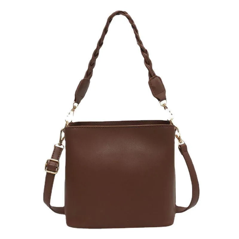 Woven texture PU leather crossbody bucket bag in neutral colour showing one-shoulder underarm carrying design