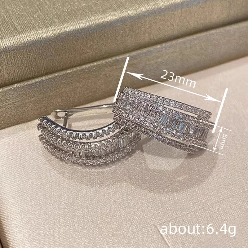 White gold coloured geometric stud earrings with zircon stone accents on copper metal for women