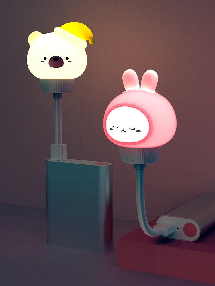 Cartoon bear-shaped USB night light with remote control on bedside table