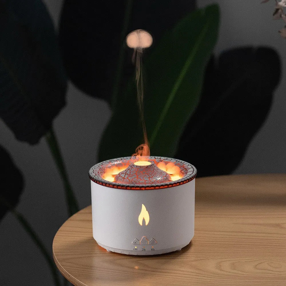 Volcanic-shaped humidifier emitting a two-colour mist from its spray ring on a table.