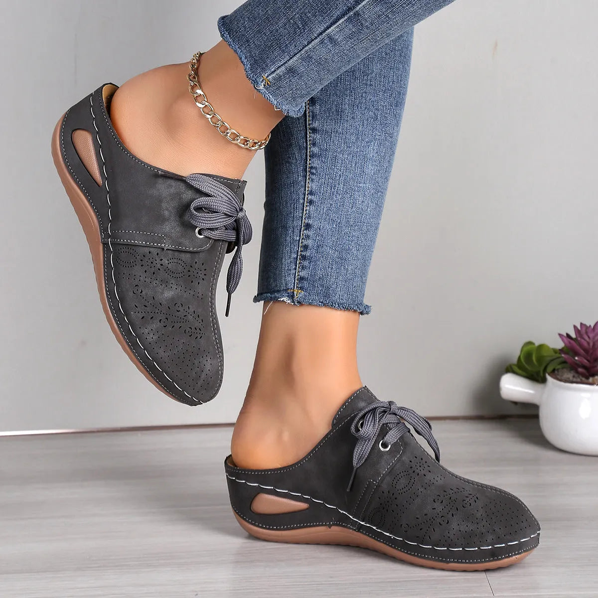 Women's suede lace-up wedge slippers in light grey, showing hollow-out design and rubber sole.