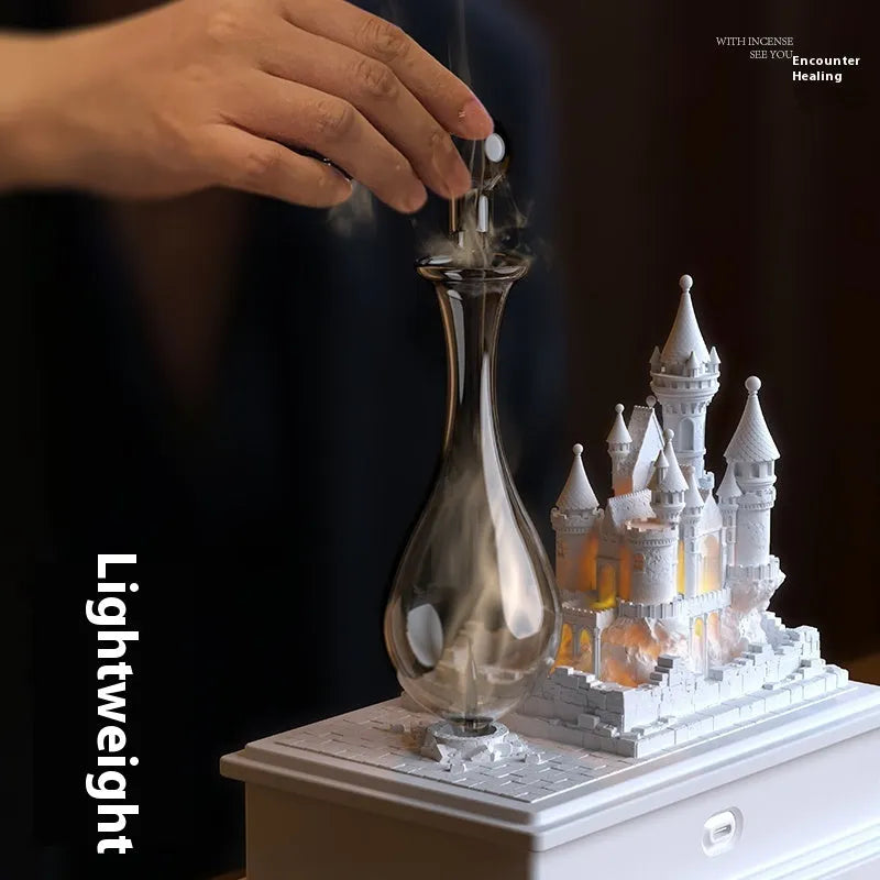 White medieval castle shaped aromatherapy machine with ambient lighting on a table.