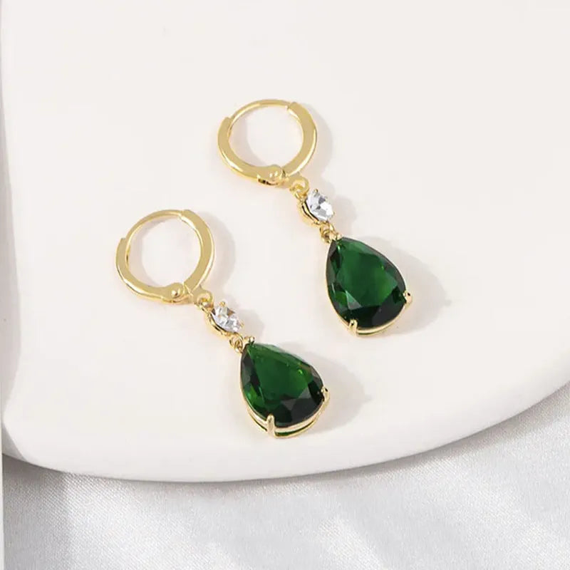 Green geometric teardrop alloy earrings with drop design on display
