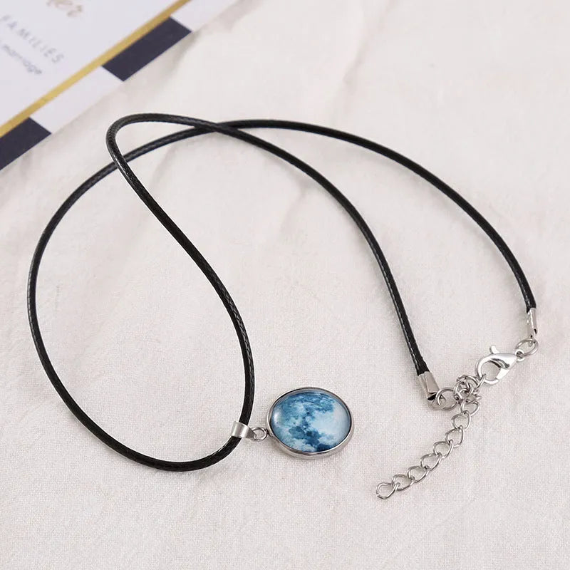 Christmas moon and night sky luminous constellation pendant on a glass necklace chain.