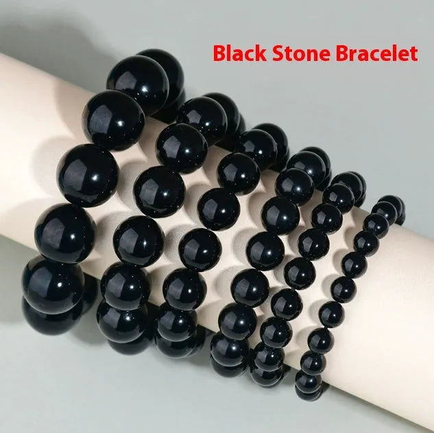 Hand-woven round obsidian crystal bracelet in ethnic style on a wrist, showing colour and bead size options.