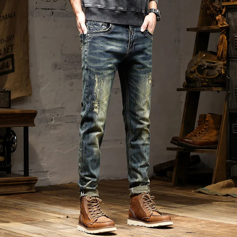 Men's skinny fit retro blue jeans with a high waist and zip fly on a plain background.