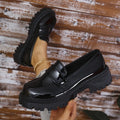 Plus size women's black slip-on loafers with a chunky platform heel and rubber sole.