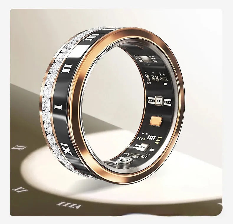 Silver and gold smart ring with diamond inlay on finger, showing charging cable and box.