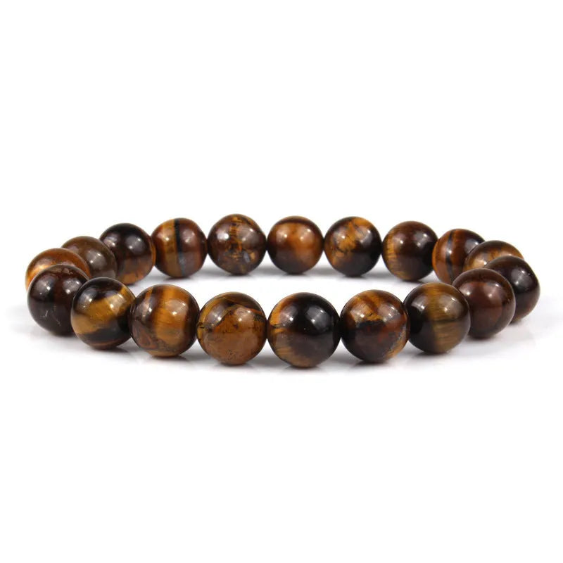 Natural tigereye crystal beaded bracelet with round beads, shown in a selection of colours and sizes on a wrist.