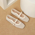 Women's low heel mesh pump in beige with a buckle strap and square toe.