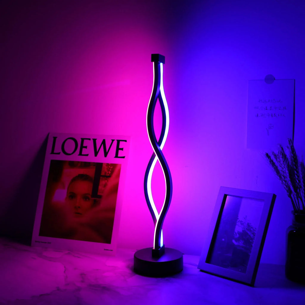 Black aluminum desk lamp with a touch dimming base on a wooden desktop.