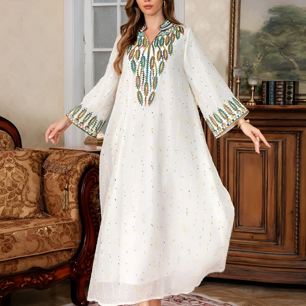 White floor-length Arabic robe with long sleeves on a hanger.