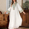 White floor-length Arabic robe with long sleeves on a hanger.