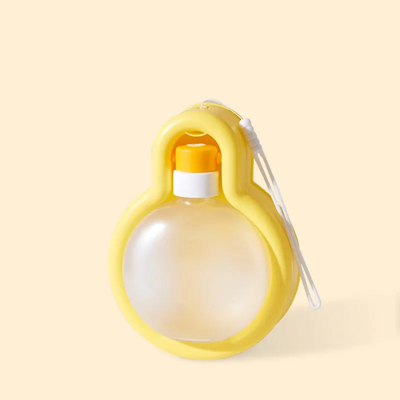 Green portable dog water bottle with retractable drinking bowl for travel and outdoor use.