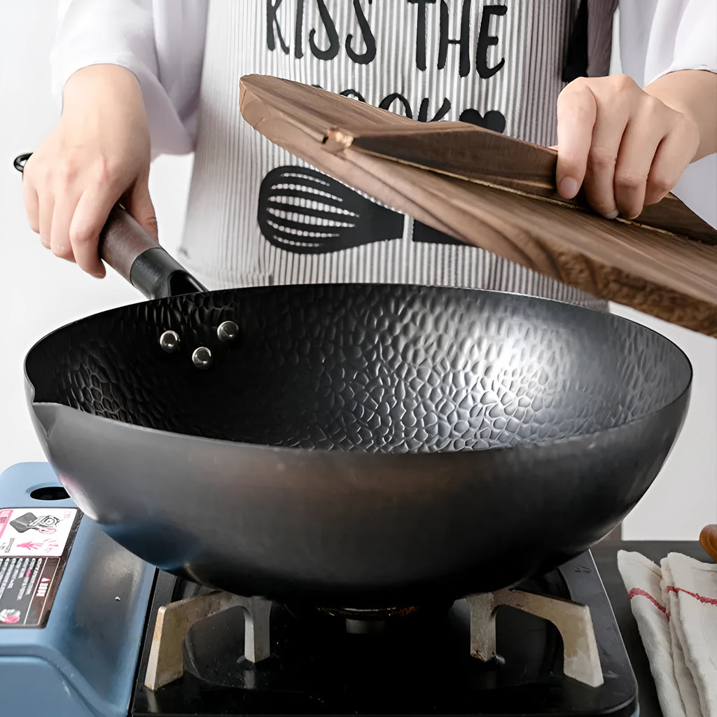 Traditional handmade iron wok pan with wooden handle and black finish, 40cm diameter