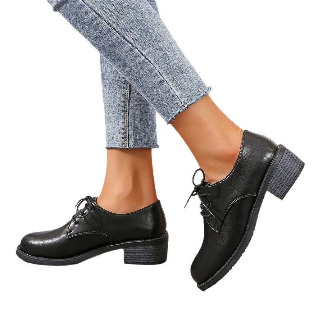 Black women's low-top work shoes with a chunky heel and pointed toe.